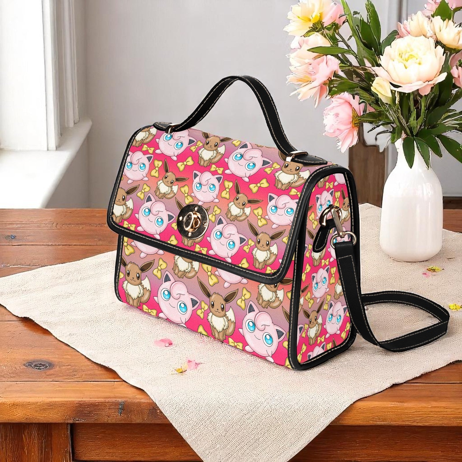 Pink eeveelution handbag featuring evolution characters on geometric background - adjustable shoulder strap with magnetic closure