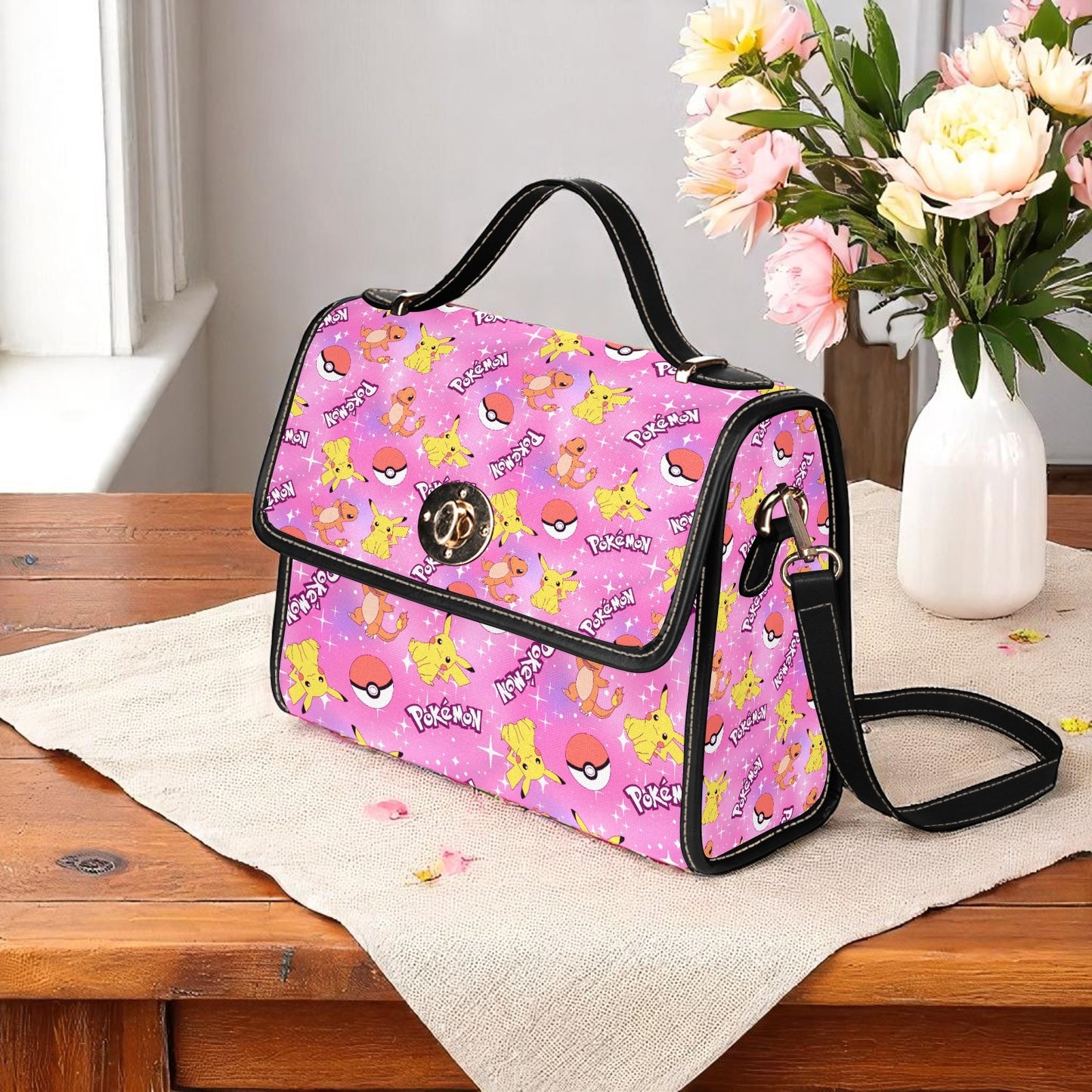 Pink anime gaming handbag featuring electric mouse characters and sphere designs - adjustable shoulder strap and magnetic flap closure